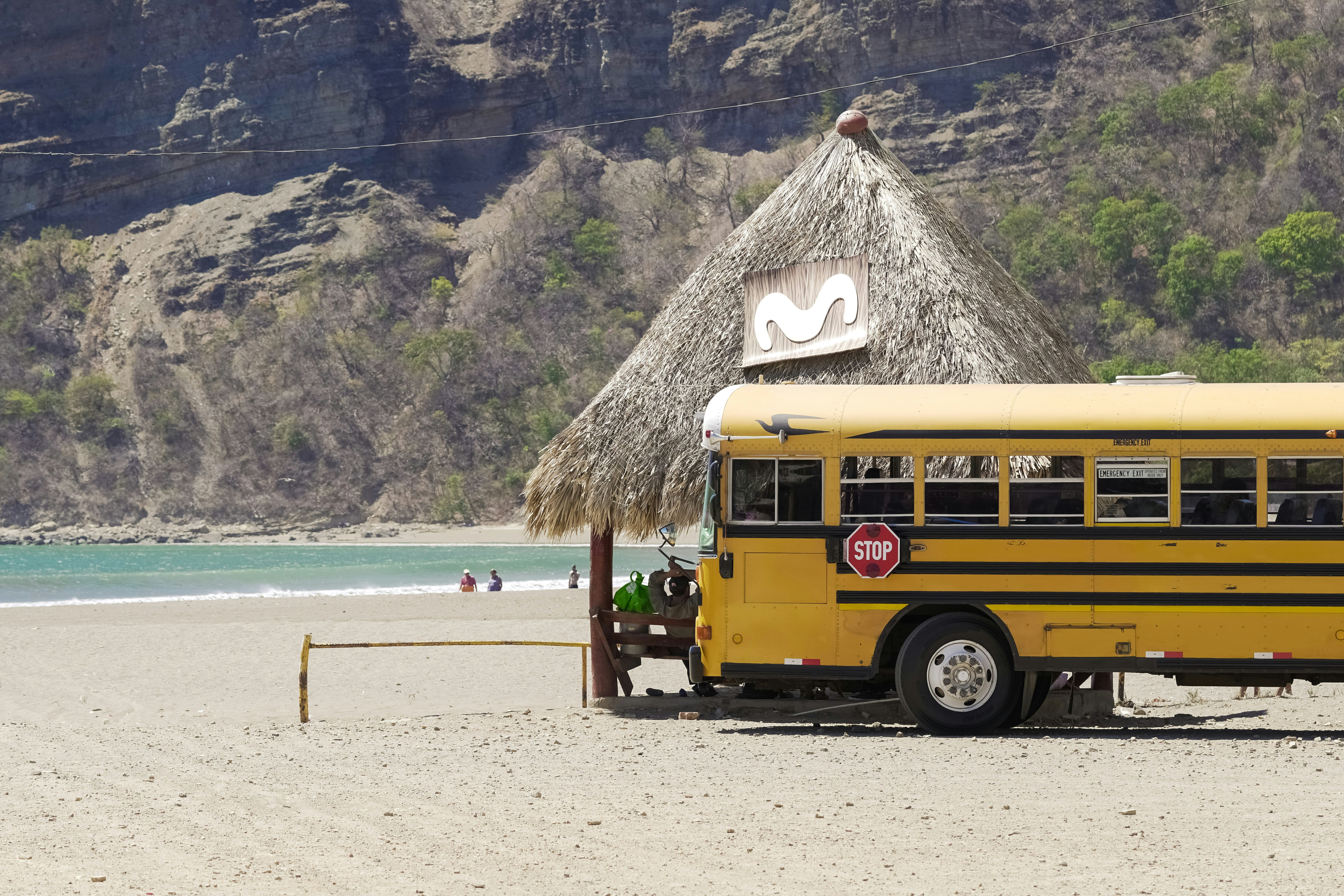 yellow school bus on beach during daytime